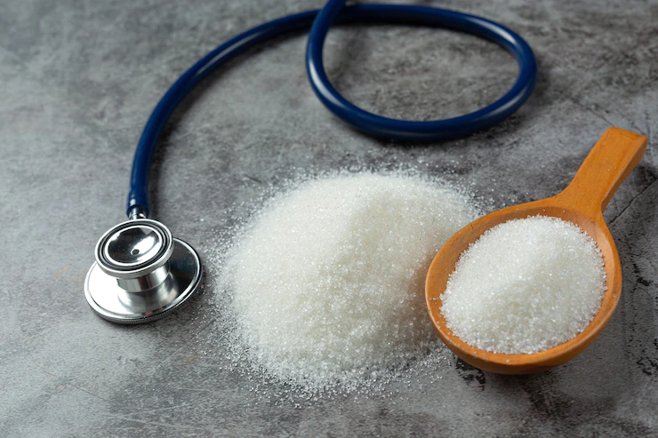 World diabetes day; sugar in wooden bowl and stethoscope on dark background Free Photo