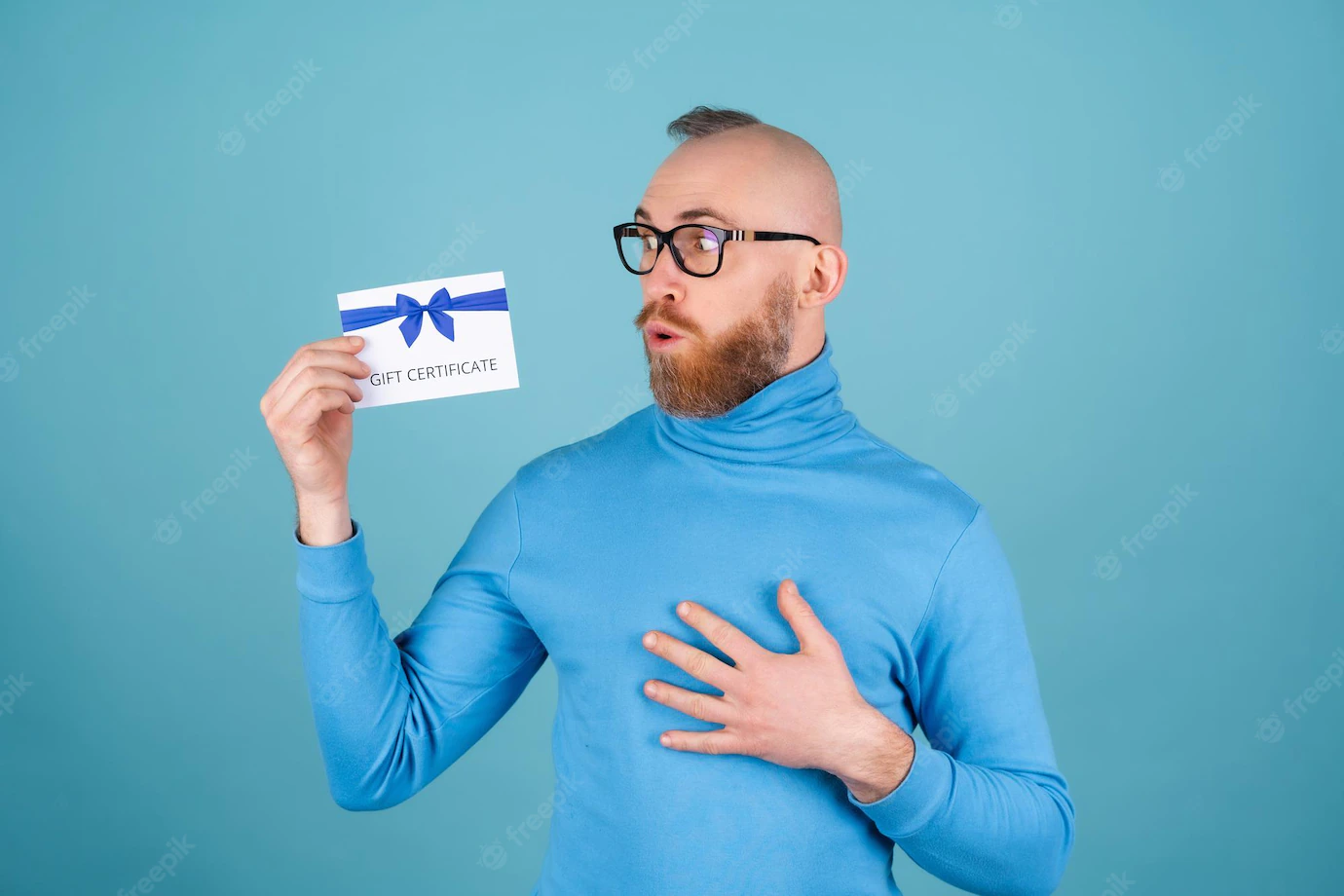 Young Man With Red Beard Turtleneck Glasses Blue Background Holds Gift Certificate Smiles Cheerfully Perky Mood 343596 7864
