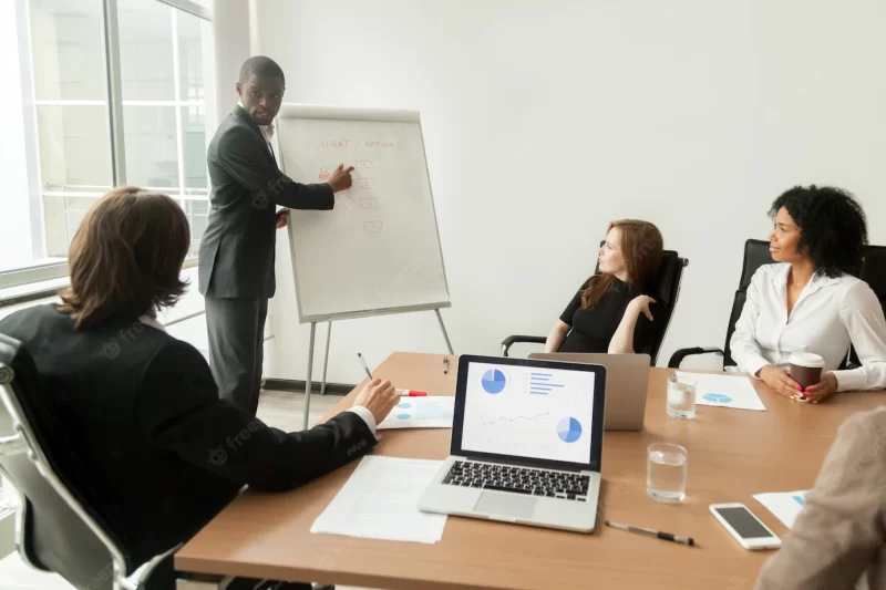 African-american businessman giving presentation explaining new marketing plan at meeting Free Photo