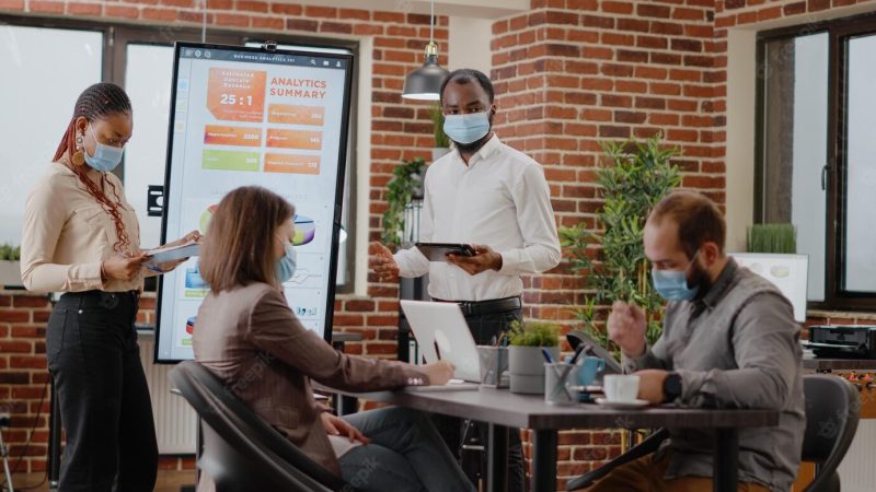 African American coworkers showing financial analysis on display, doing charts presentation in meeting office. business people using monitor to design marketing project and strategy. Free Photo