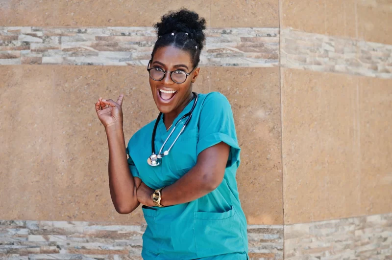 African american doctor female at lab coat with stethoscope posed outdoor against clinic Free Photo