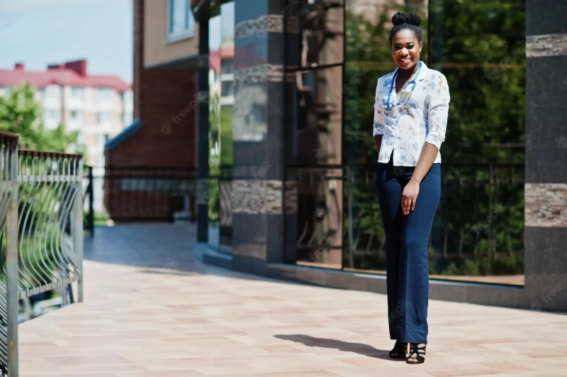 African american doctor female with stethoscope posed outdoor against clinic Free Photo