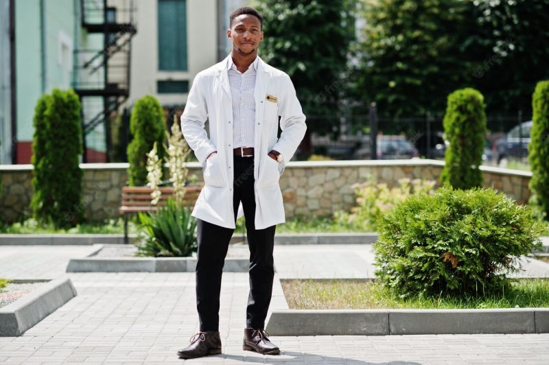 African american doctor male at lab coat with stethoscope outdoor Free Photo