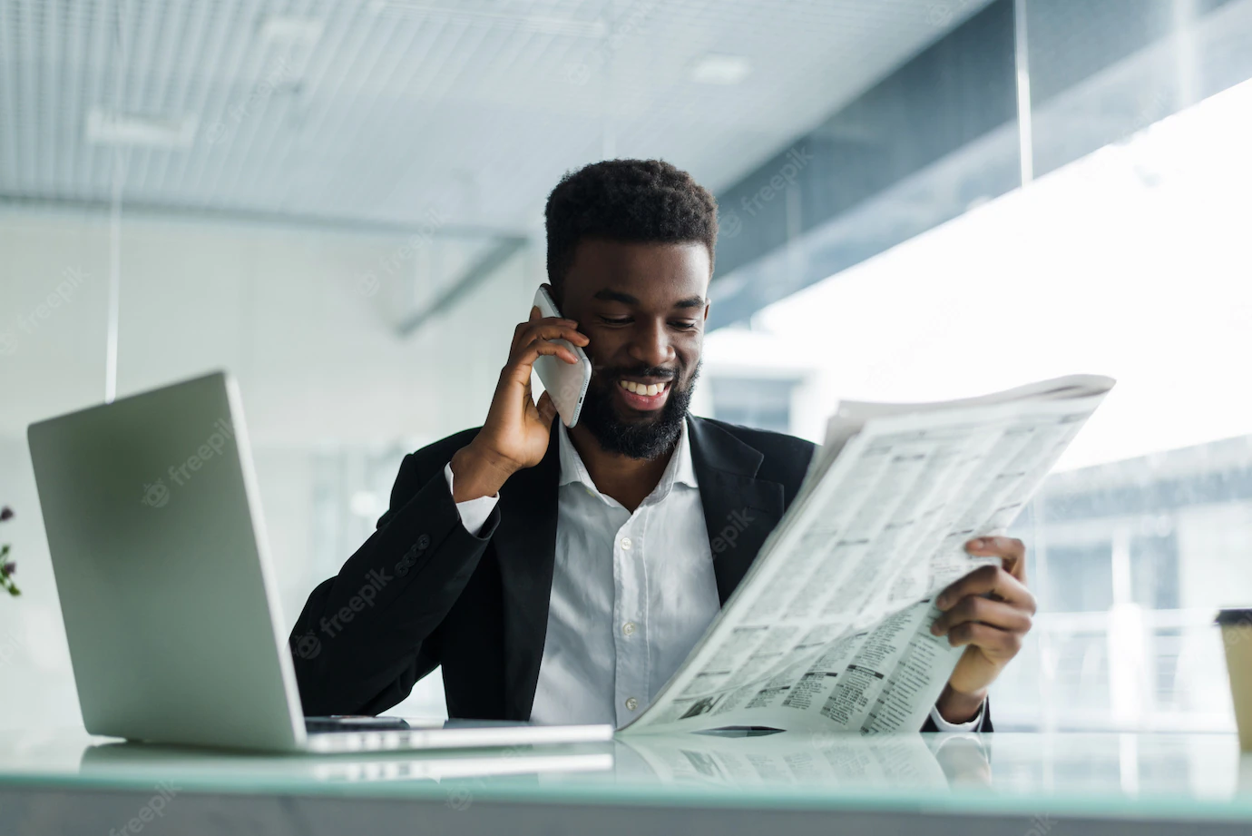 African American Man Reading Newspaper Talking Phone Office 231208 722