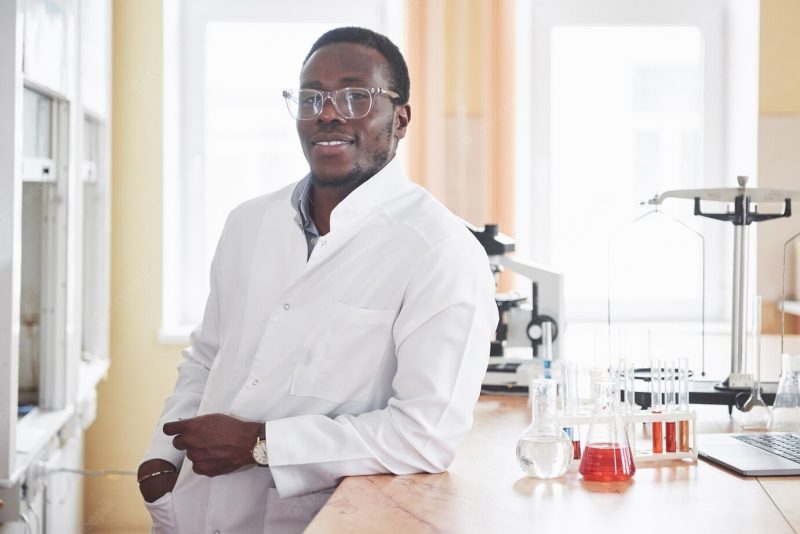 An African American worker works in a laboratory conducting experiments. Free Photo