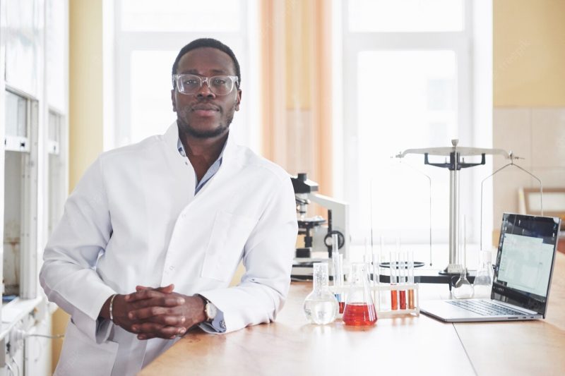 An African American worker works in a laboratory conducting experiments. Free Photo