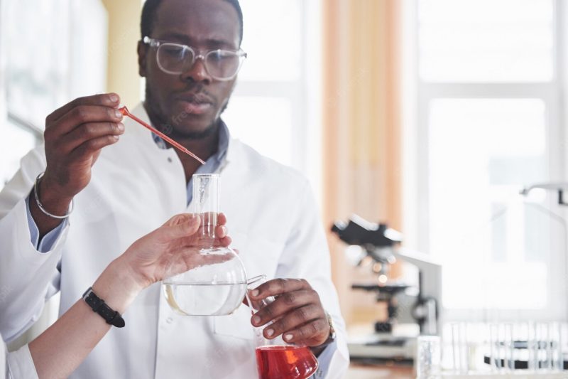 An African American worker works in a laboratory conducting experiments. Free Photo