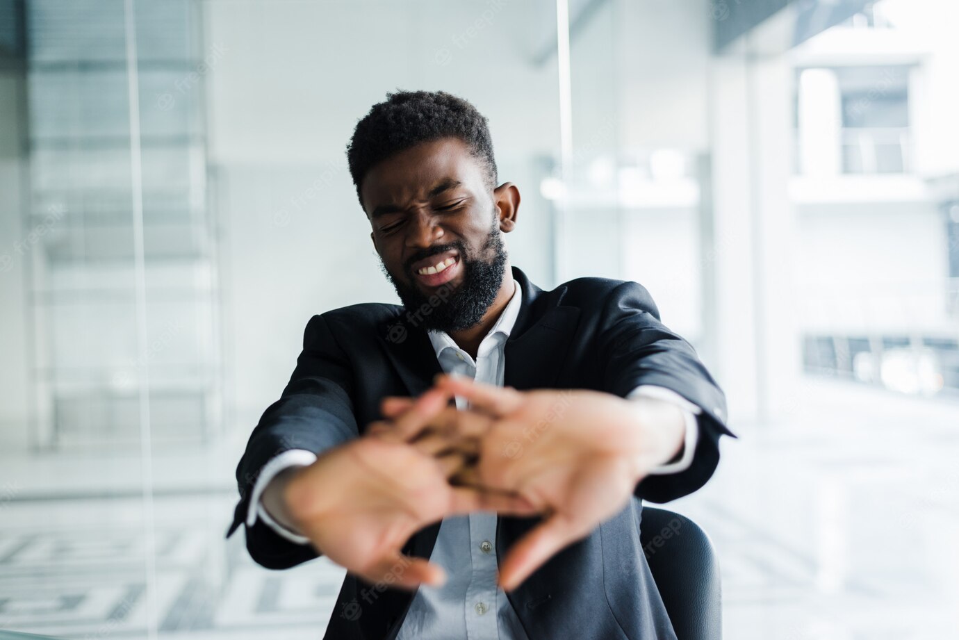 African Businessman Take Break During Workday Stretching Hands Fingers Starting Office Work 231208 801