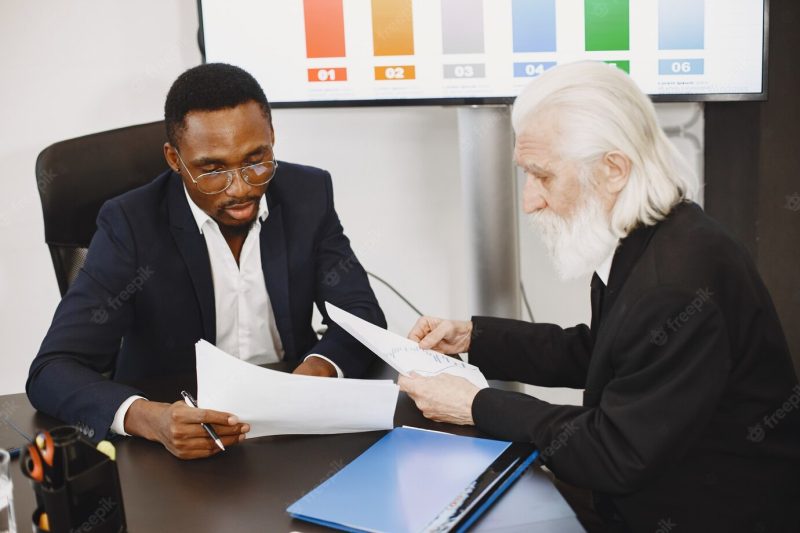 African man in a black suit. Free Photo