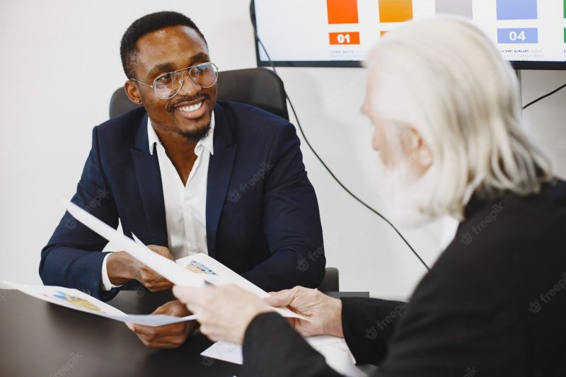 African man in a black suit. Free Photo