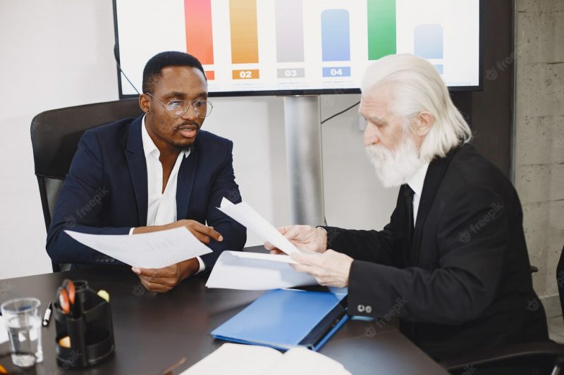 African man in a black suit. Free Photo