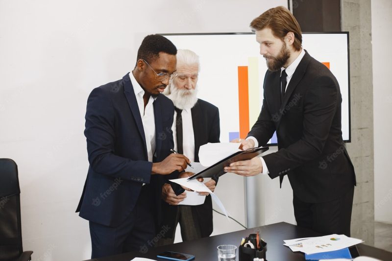 African man in a black suit. Free Photo