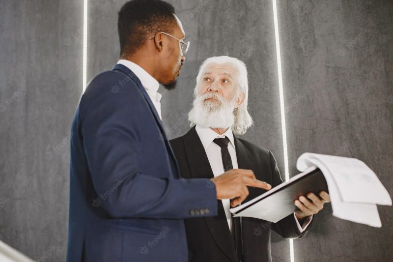 African man in a black suit. Free Photo