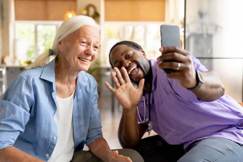 African social worker taking care of a senior woman Free Photo