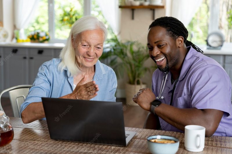 African social worker taking care of a senior woman Free Photo