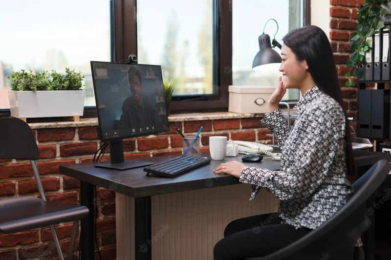 Agency office worker in virtual remote video conference with accounting manager talking about business plan. asian team leader in internet online call conversation with agency colleague. Free Photo