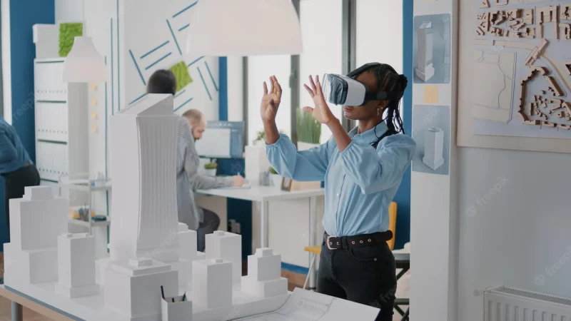 Architect using vr glasses to design building model and construction layout. woman contractor working with virtual reality headset to plan real estate structure, creating urban project. Free Photo