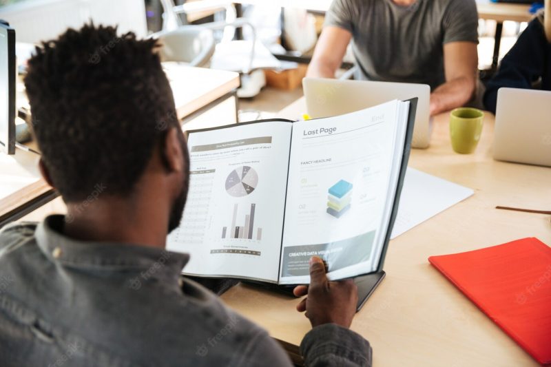 Back view picture of African man sitting in office co-working Free Photo