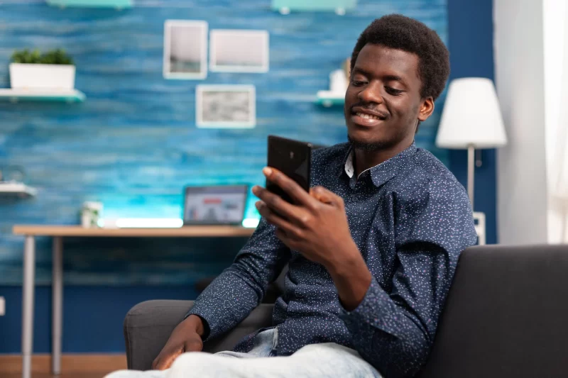 Black man greeting colleagues on video call conference Free Photo