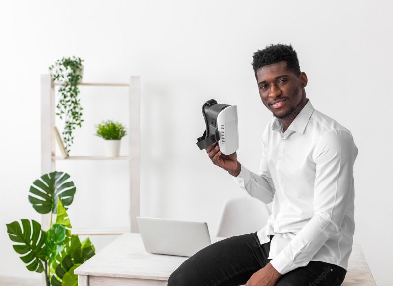 Business African American man holding vr set Free Photo