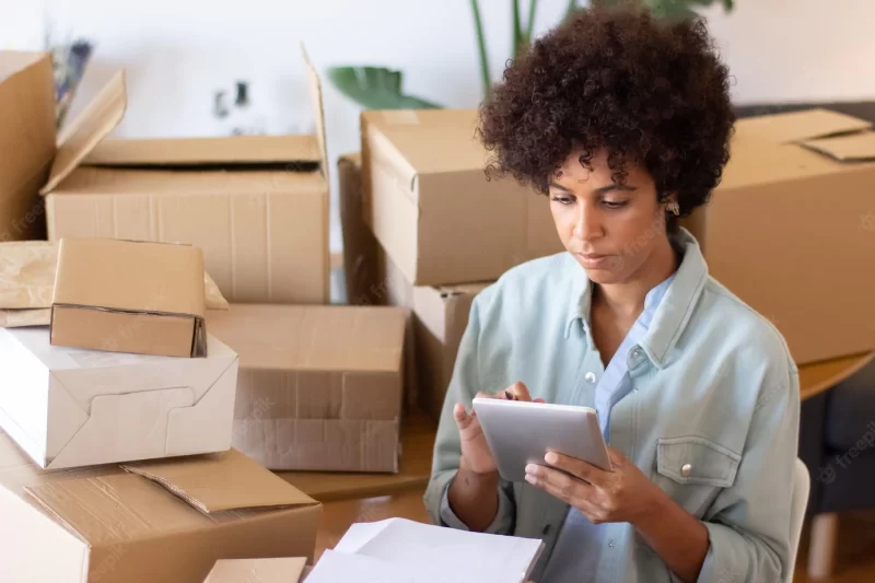 Busy African American woman using tablet Free Photo