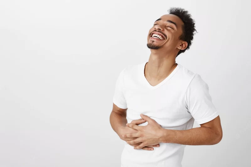 Carefree african american man laughing and smiling, hear funny joke Free Photo