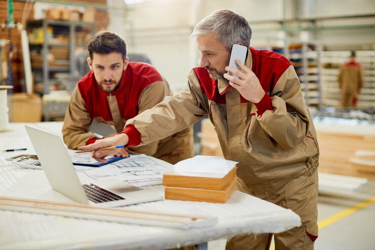 Carpenter Talking Phone While Using Computer Workshop 637285 11831