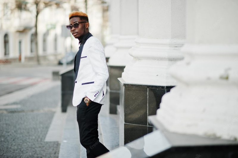 Chic handsome African American man in white suit and sunglasses Free Photo