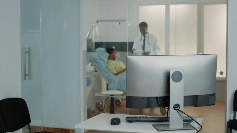 Close up of desk with computer in hospital ward clinic to check patient information and files. space with monitor used for online medical documents and healthcare system. emergency room Free Photo