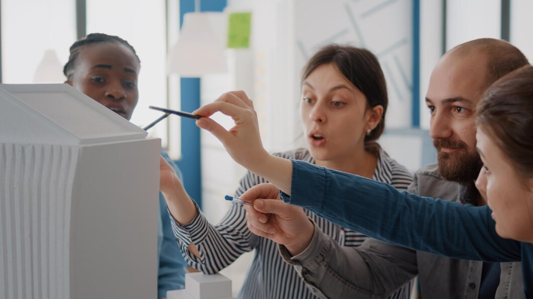 Close Up Workmates Analyzing Building Model Maquette Table Design Construction Group Diverse Colleagues Working Architecture Project Structure Development 482257 33694