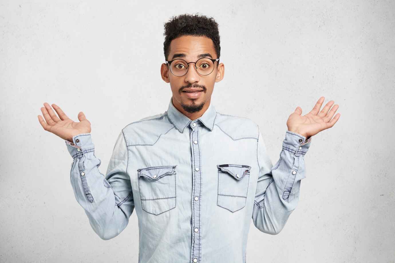 Cropped Shot Fashionable Young Male Wears Denim Clothes Glasses Gestures With Hands 273609 8725