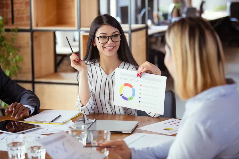 Diverse group of co-workers having casual discussion in office Free Photo