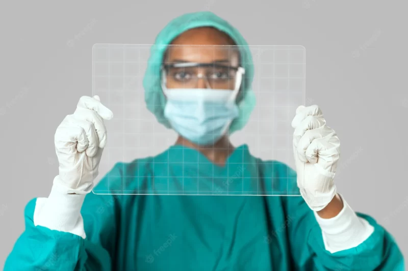 Doctor holding futuristic transparent tablet screen Free Photo