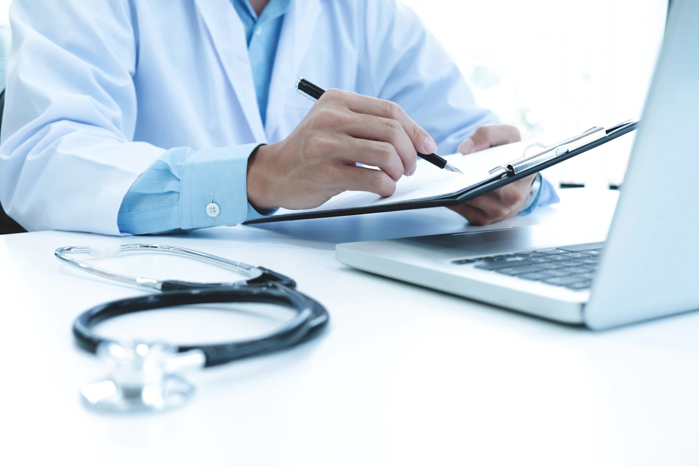 Doctor Working With Laptop Computer Writing Paperwork Hospital Background 1421 69