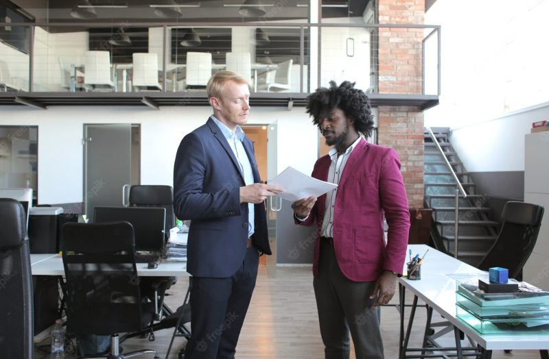 European and african-american business partners discussing a contract during a business meeting Free Photo