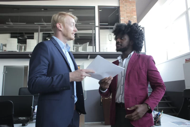 European and african-american business partners discussing a contract during a business meeting Free Photo