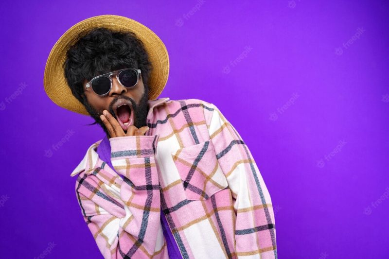 Fashion portrait of african american man in glasses against purple background Free Photo