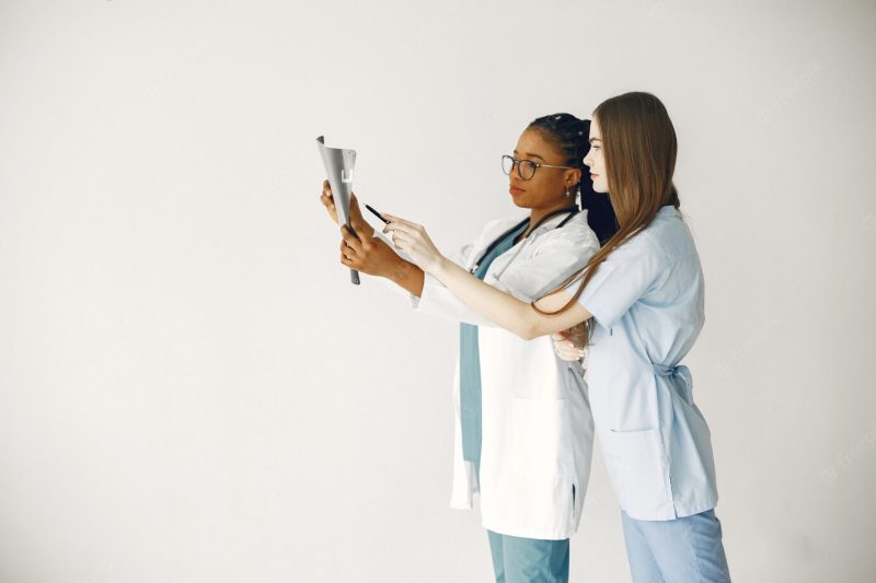 Female doctors in bathrobes. African girl. stethoscope on doctor’s neck. Free Photo