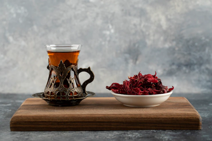 Glass Cup Hot Tea With Dried Flowers Wooden Cutting Board 114579 53446