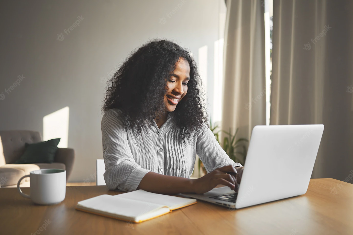 Gorgeous Positive Young Dark Skinned Female Blogger Keyboarding Generic Laptop Smiling Being Inspired While Creating New Content Her Travel Blog Sitting Desk With Diary Mug 343059 1535