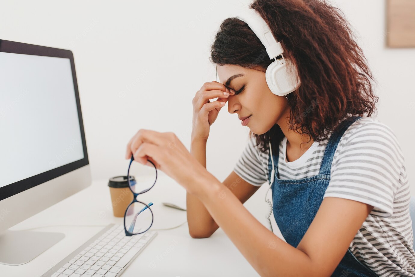 Graceful Black Woman Headphones With Headache Sitting Beside Computer Holding Glasses Hand 197531 4879