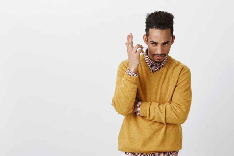 Guy displeased from slow talk of his friend. portrait of confused puzzled dark-skinned man, holding hand raised while looking with displeasure and doubt, arguing or discussing bad news Free Photo