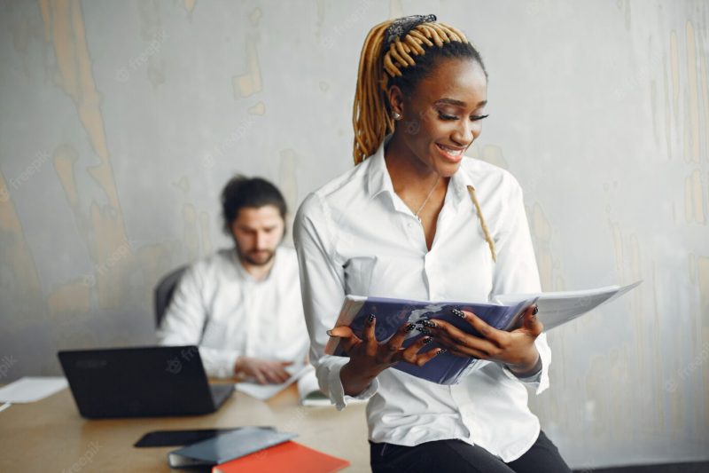 Handsome man in a white shirt. african woman with partner. guy with a laptop. Free Photo