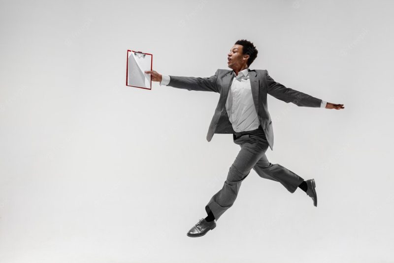 Happy businessman dancing in motion isolated on white studio background. flexibility and grace in business. human emotions concept. office, success, professional, happiness, expression concepts Free Photo