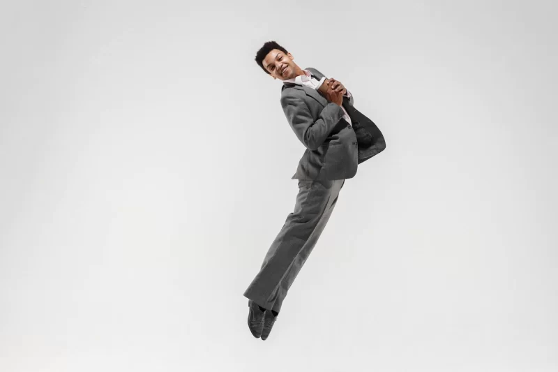 Happy businessman dancing in motion isolated on white studio background. flexibility and grace in business. human emotions concept. office, success, professional, happiness, expression concepts Free Photo