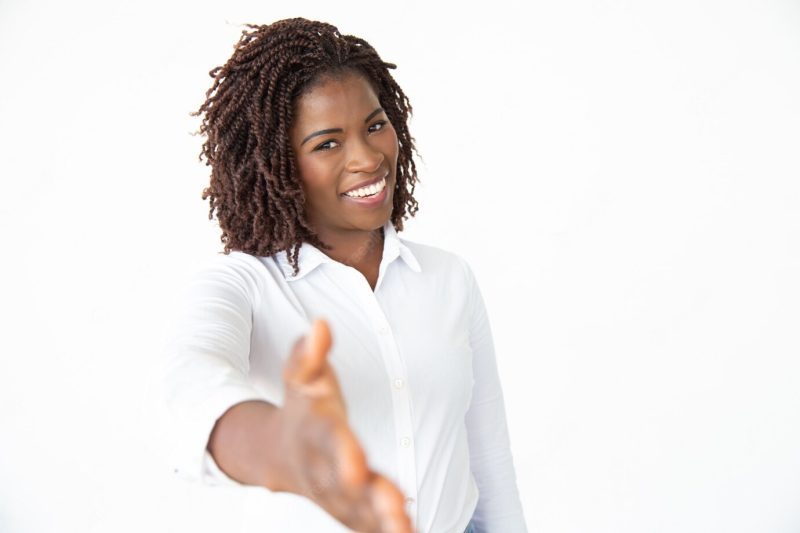 Happy businesswoman reaching hand for handshake Free Photo