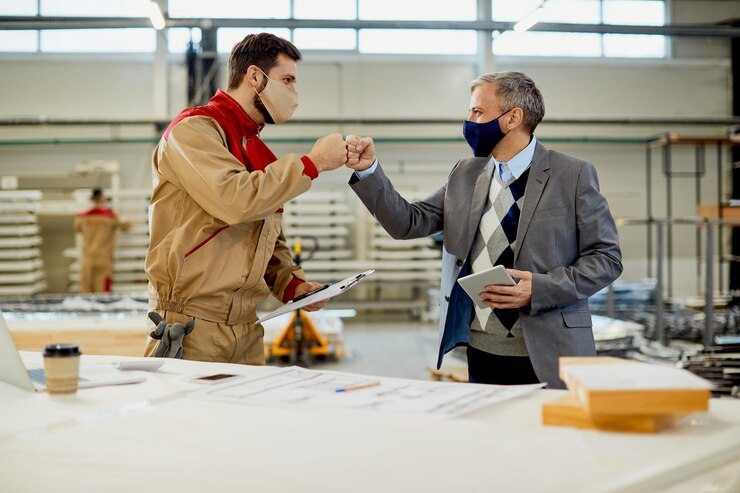 Happy Carpenter Fist Bumping With Inspector While Greeting During Coronavirus Pandemic 637285 11837