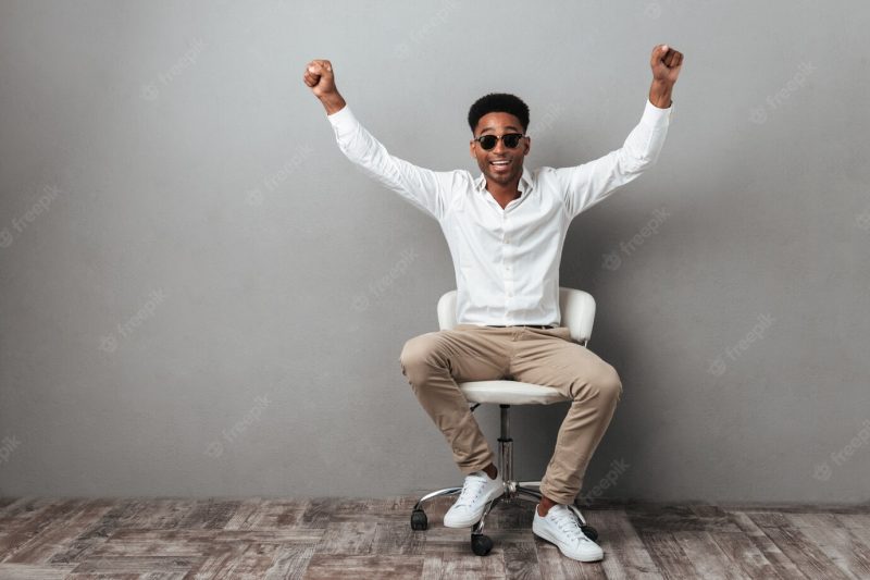 Happy excited African man in sunglasses celebrating success Free Photo