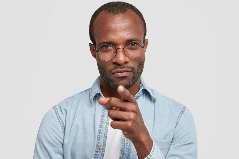 Headshot of dark skinned male with serious expression Free Photo