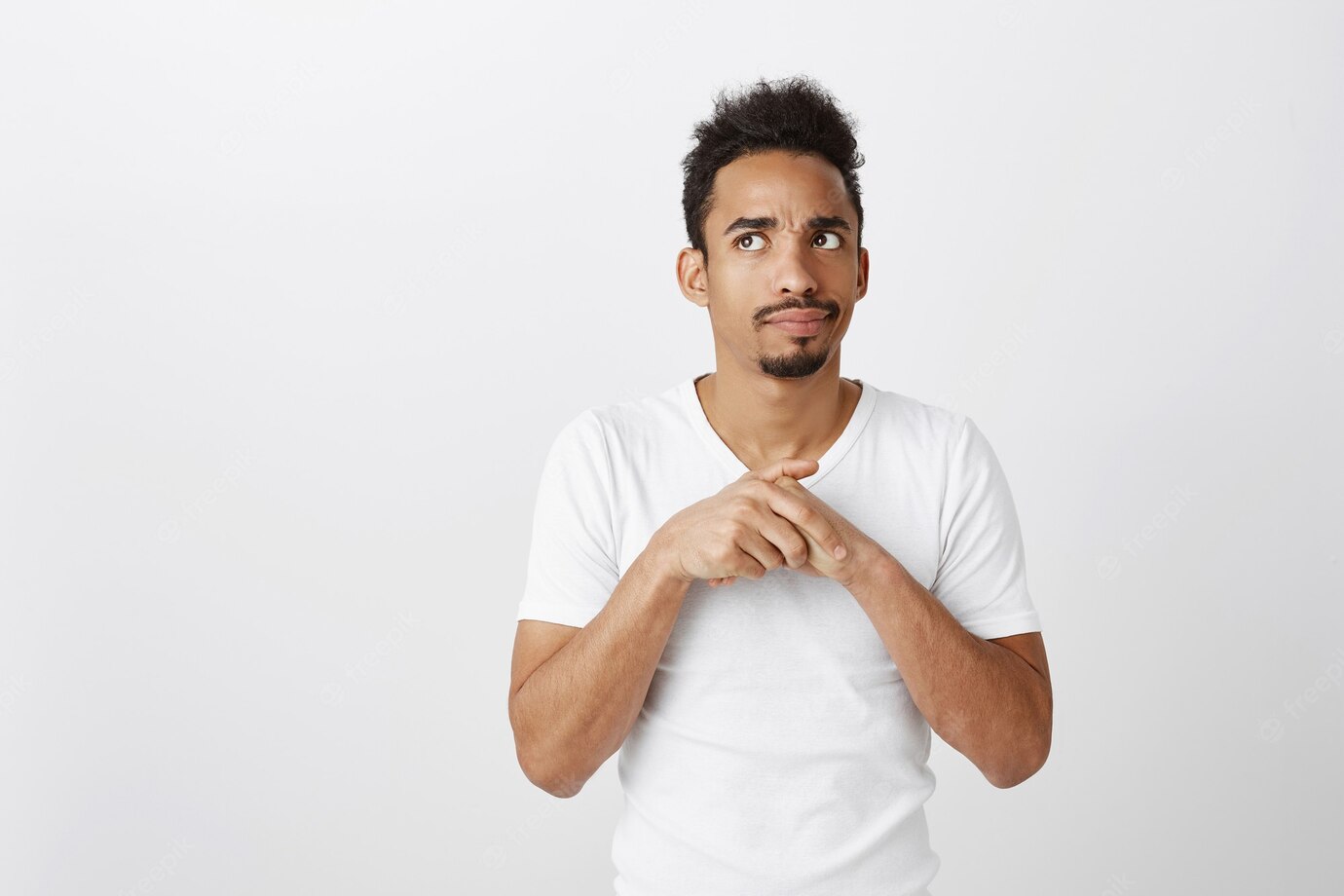 Indecisive African American Thoughtful Guy Looking Upper Left Corner With Uncertain Expression 176420 25206